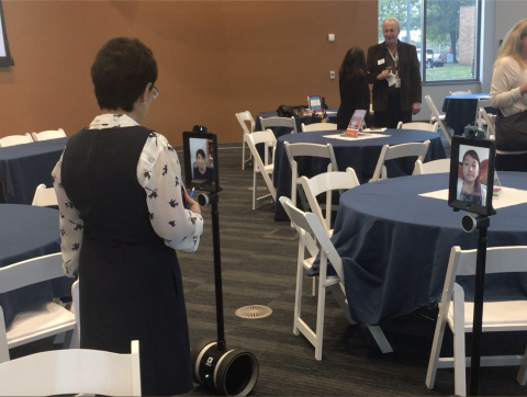 Student uses mobile telepresence robot for virtual meeting.